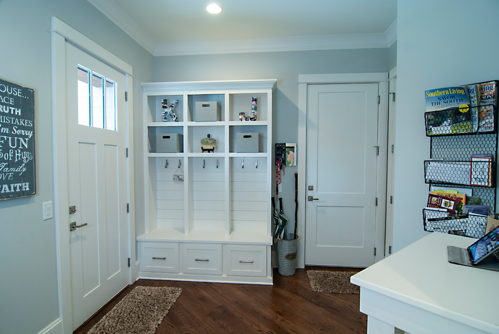 Photo of a medium sized classic boot room in Charlotte with grey walls, medium hardwood flooring, a single front door, a white front door and brown floors.