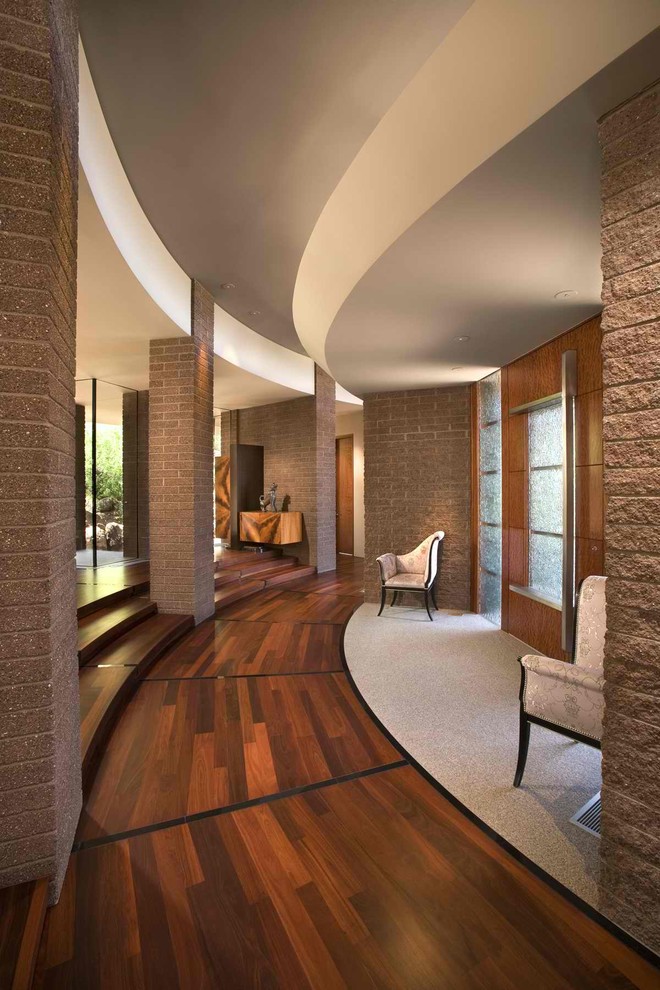 Foyer - contemporary foyer idea in Phoenix with a medium wood front door