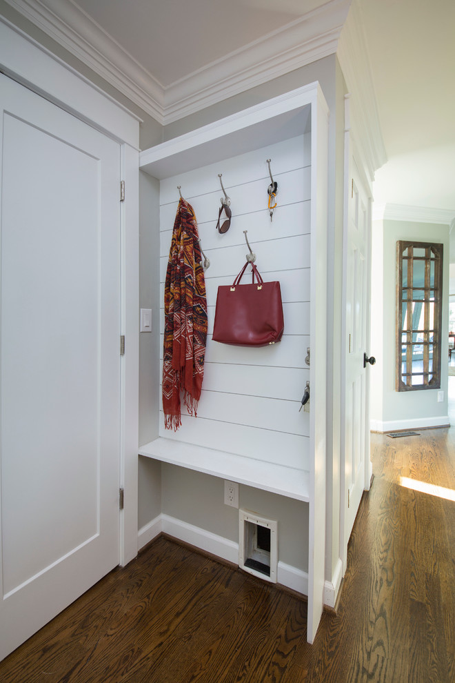 Inspiration for a small transitional medium tone wood floor mudroom remodel in Other with gray walls