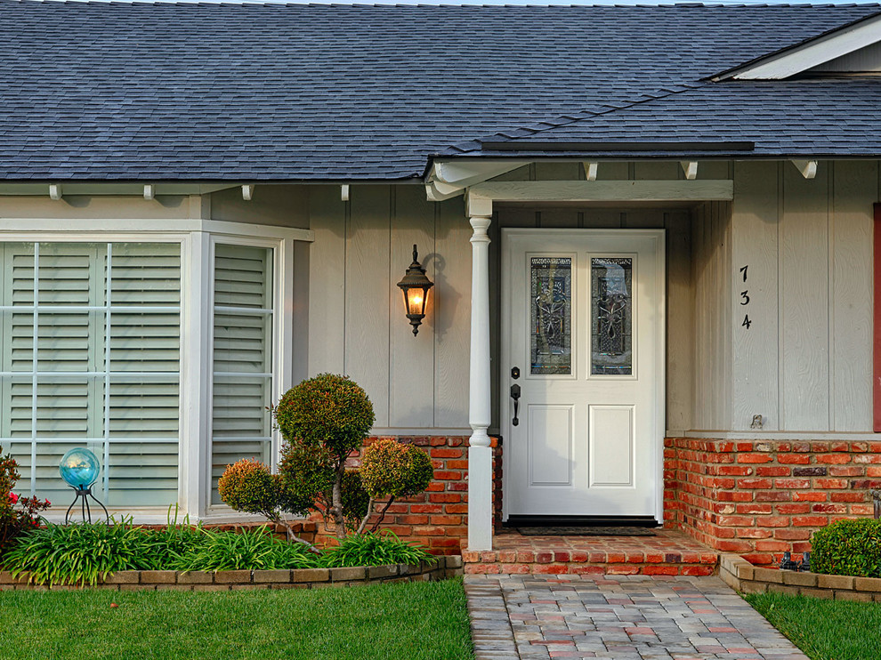 Photo of a large traditional front door in Orange County with grey walls, a single front door and a white front door.
