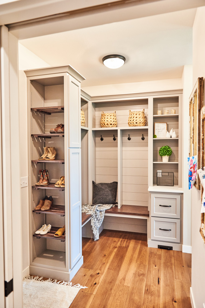 Inspiration for a mid-sized farmhouse light wood floor and brown floor mudroom remodel in Cedar Rapids with gray walls