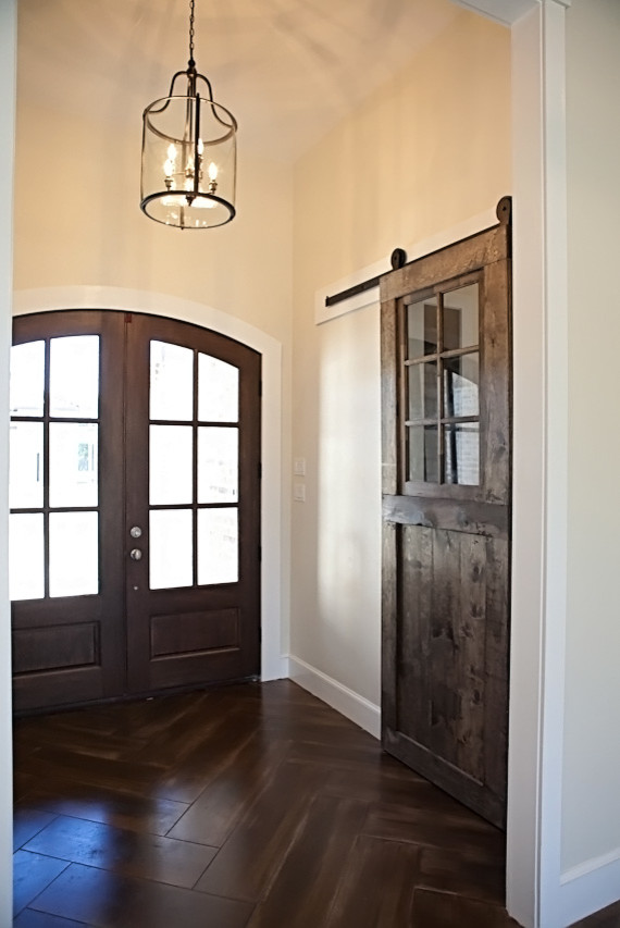 На фото: узкая прихожая среднего размера в стиле кантри с белыми стенами, бетонным полом, двустворчатой входной дверью и входной дверью из темного дерева с