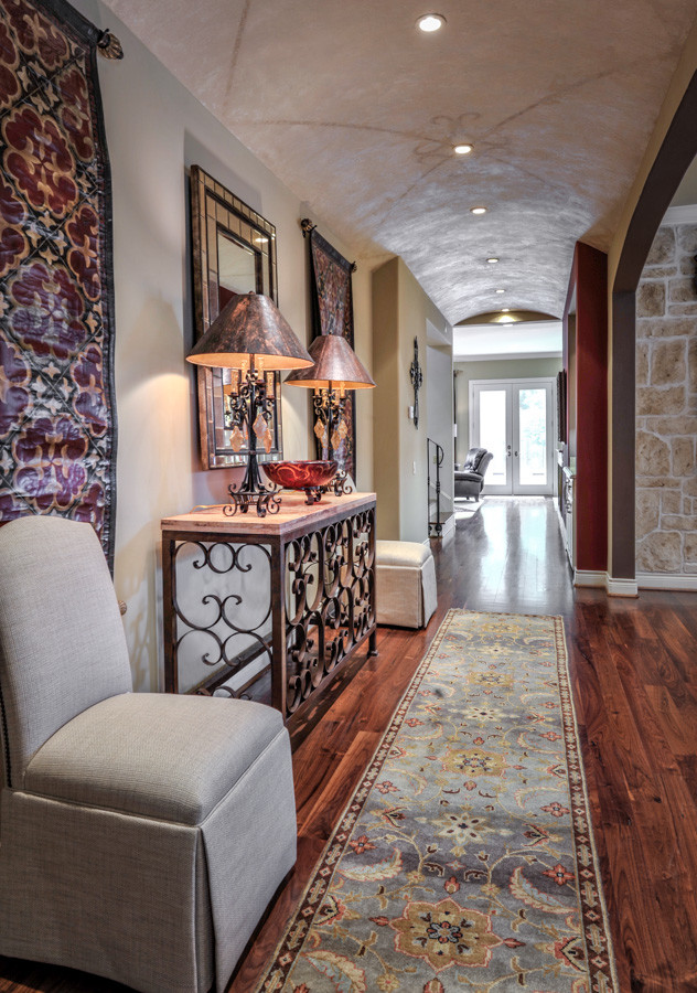 Inspiration for a large traditional hallway in Houston with beige walls, medium hardwood flooring, a double front door, a dark wood front door and brown floors.