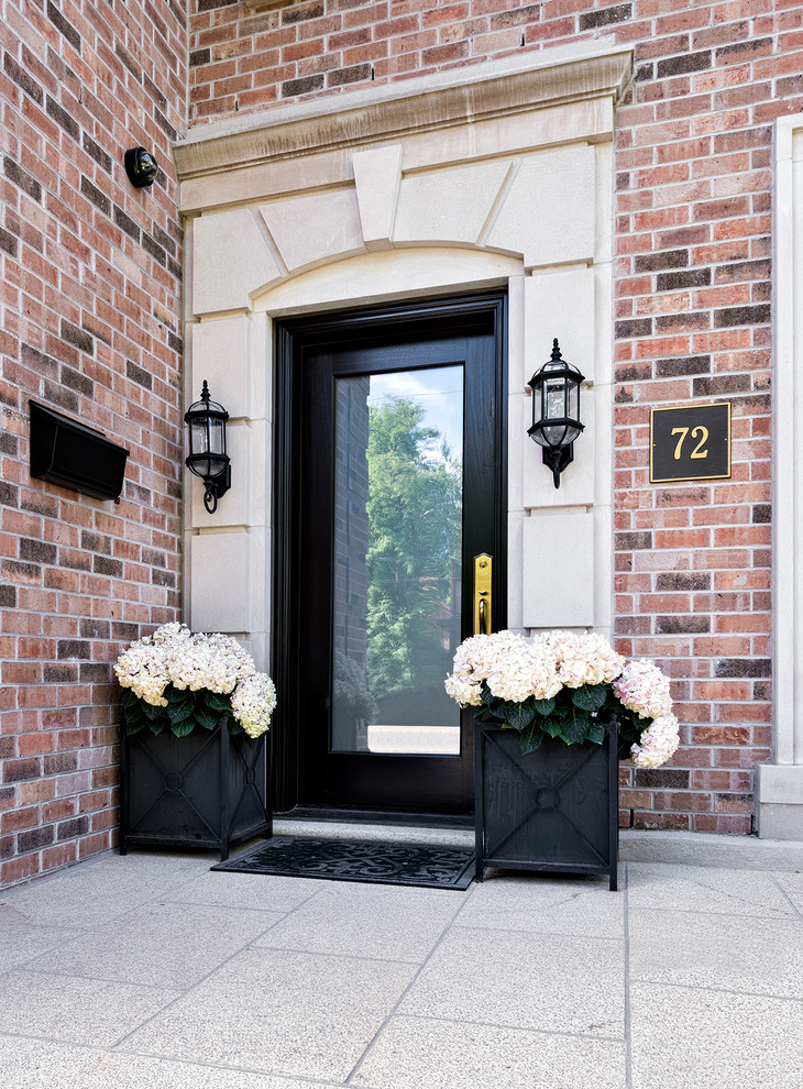 This is an example of a classic front door in Toronto with a single front door and a glass front door.