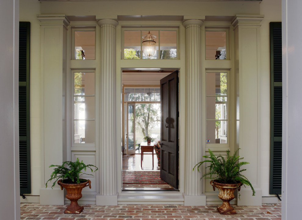 Klassische Haustür mit beiger Wandfarbe, Backsteinboden, Einzeltür und schwarzer Haustür in Atlanta
