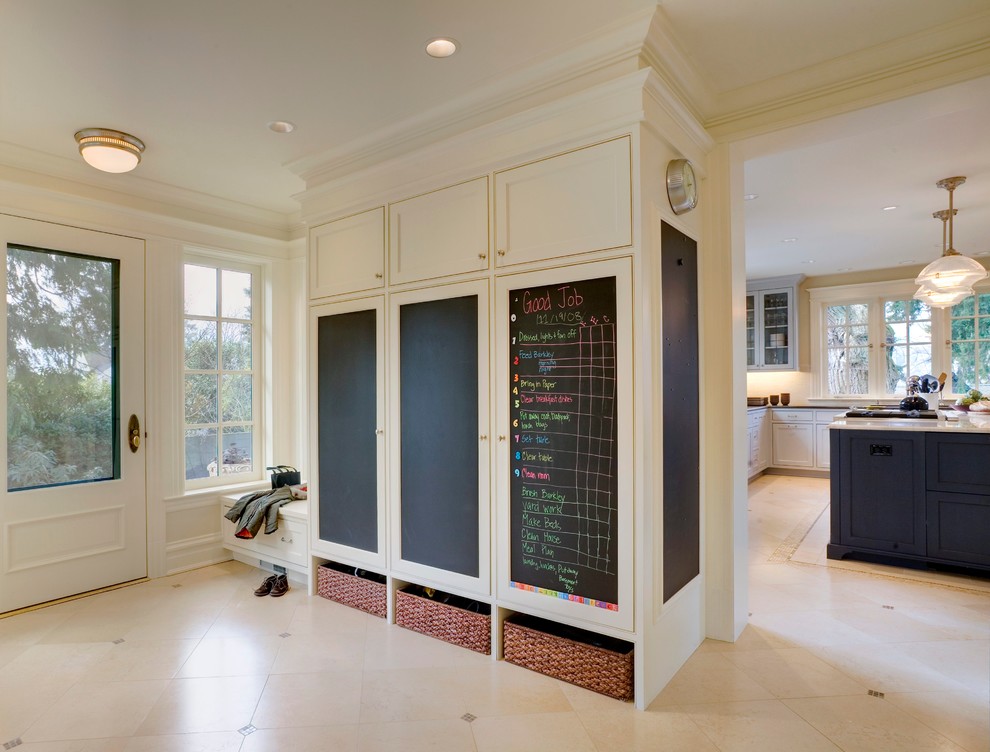 Traditional entrance in Seattle with a glass front door, beige floors and feature lighting.