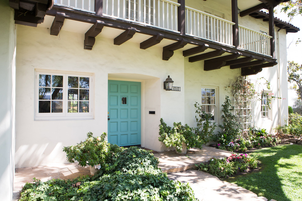 This is an example of a mediterranean front door in Los Angeles with a single front door and a blue front door.