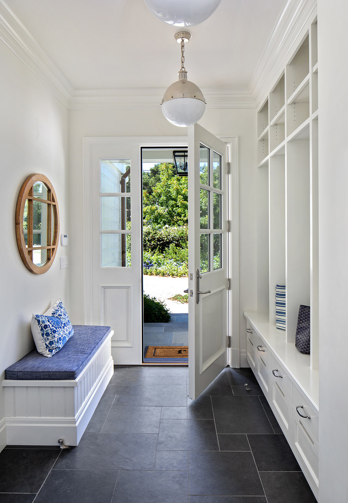 Classic boot room in San Francisco with white walls, a single front door, a white front door and black floors.