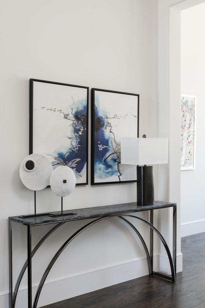 Small contemporary foyer in Dallas with beige walls, dark hardwood flooring and brown floors.