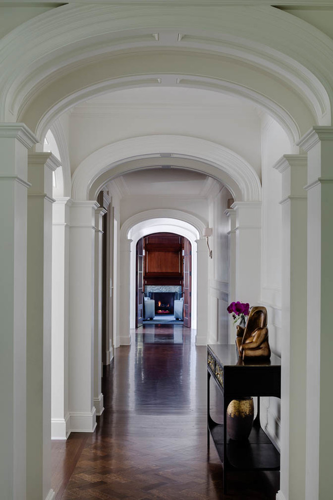 Inspiration for an expansive classic hallway in Boston with white walls, dark hardwood flooring, a double front door and a brown front door.