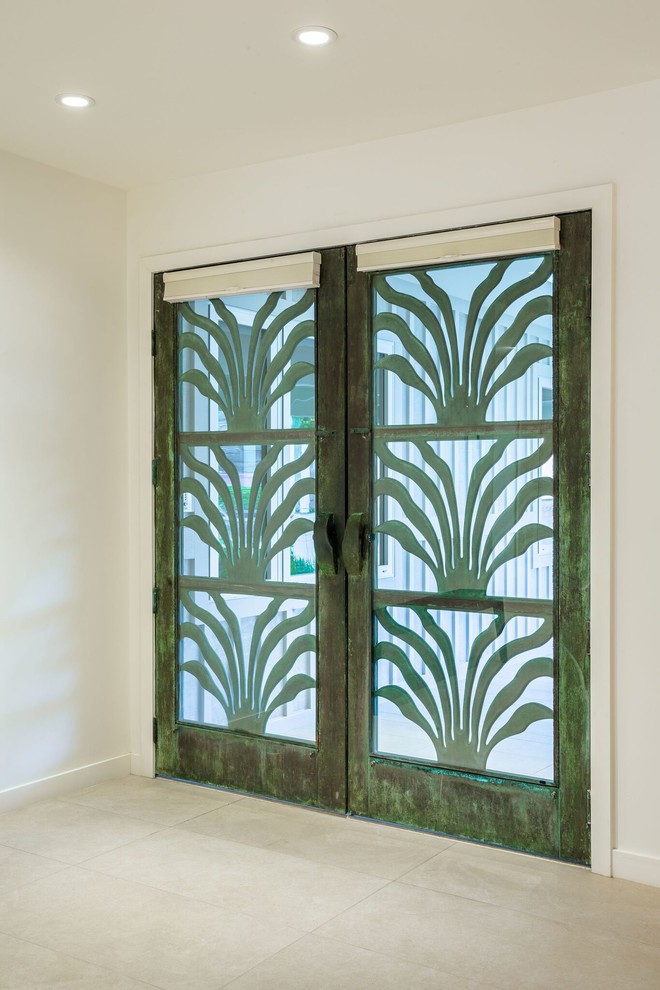 Imagen de puerta principal exótica de tamaño medio con paredes blancas, suelo de baldosas de porcelana, puerta doble, puerta verde y suelo beige