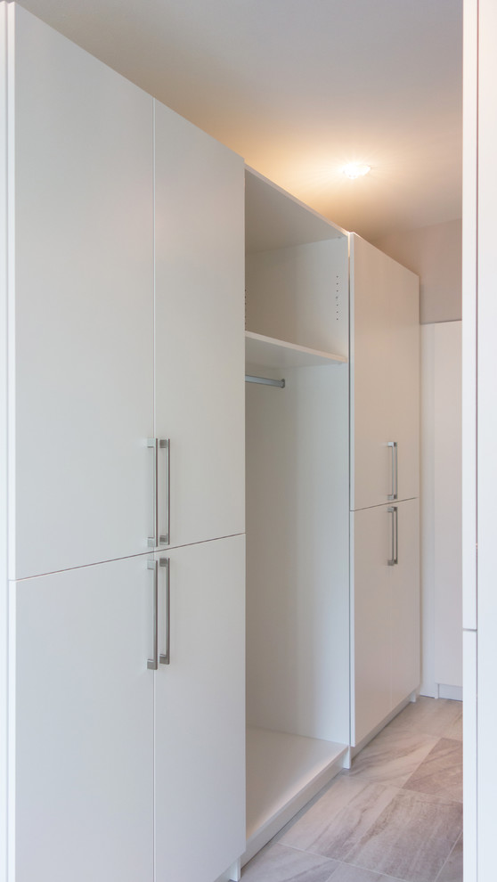 Mudroom - mid-sized contemporary porcelain tile mudroom idea in Vancouver with gray walls and a white front door