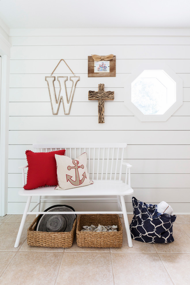 This is an example of a small vintage vestibule in Miami with white walls, a single front door and beige floors.