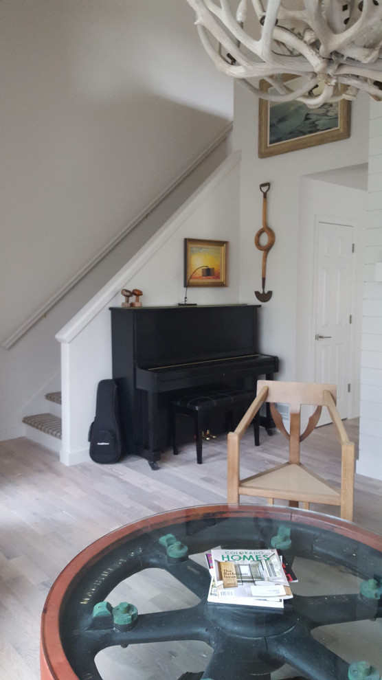 Example of a mid-sized french country open concept light wood floor, white floor, vaulted ceiling and shiplap wall living room design in Denver with a music area, white walls, a two-sided fireplace, a shiplap fireplace and a wall-mounted tv