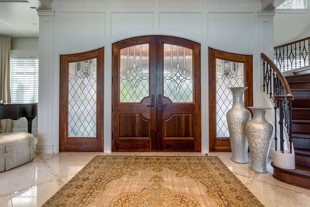 Idee per un ingresso tradizionale di medie dimensioni con pareti marroni, una porta a due ante e una porta in vetro