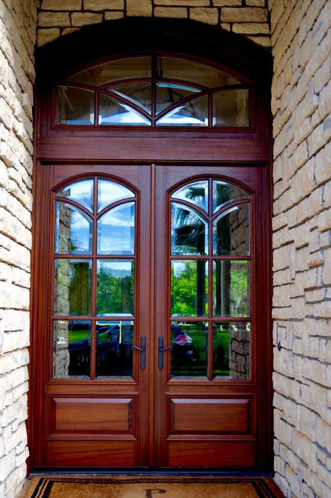 Example of an arts and crafts entryway design in Miami with a dark wood front door