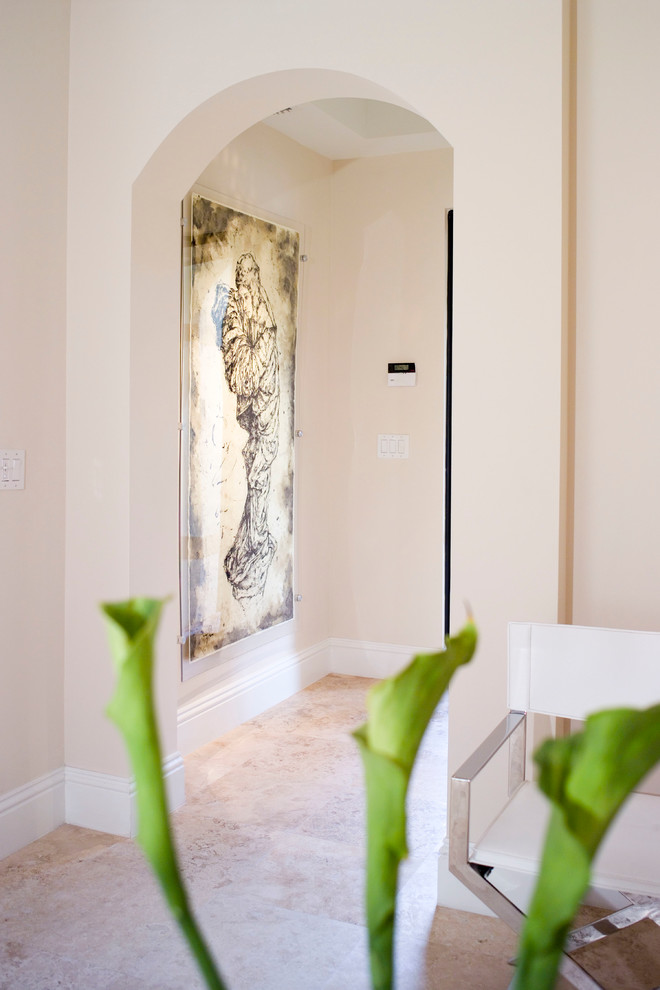 Entryway - mid-sized contemporary travertine floor entryway idea in Miami with beige walls and a glass front door