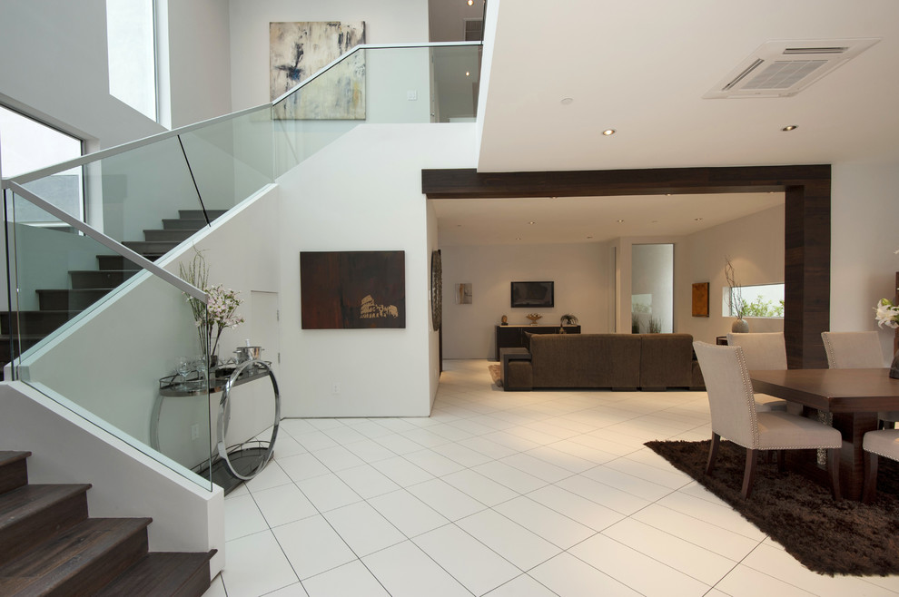 Medium sized contemporary foyer in Los Angeles with white walls and porcelain flooring.