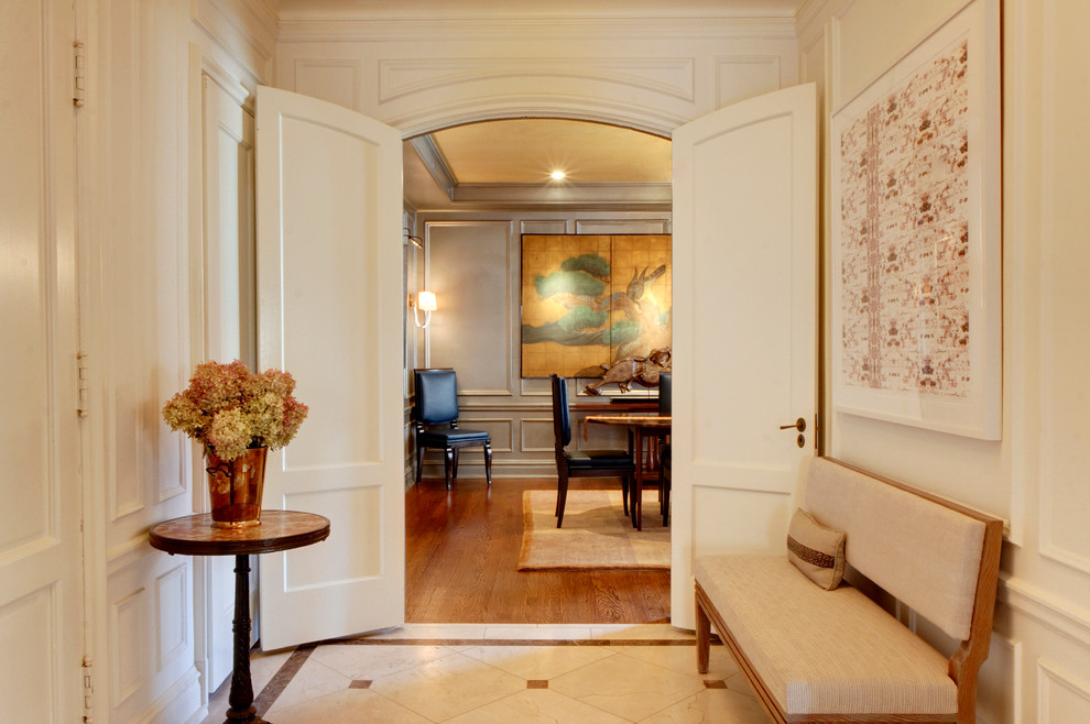 Inspiration for a mid-sized timeless marble floor entryway remodel in Chicago with white walls and a white front door