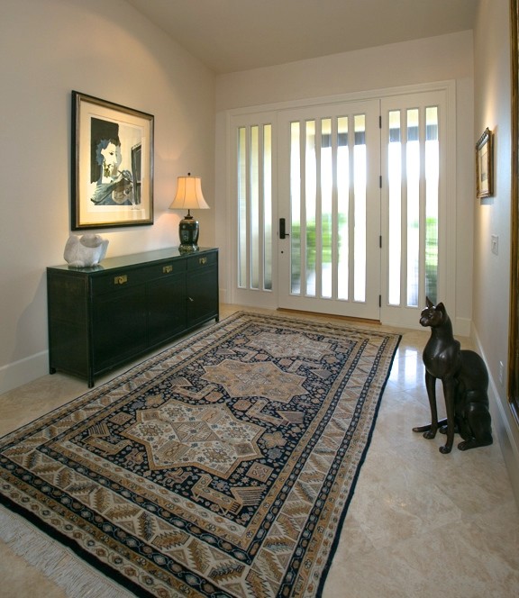 Example of a mid-sized eclectic porcelain tile and beige floor entryway design in Los Angeles with white walls and a white front door