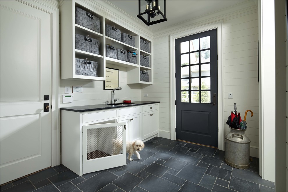 Elegant gray floor entryway photo in Minneapolis with white walls and a black front door