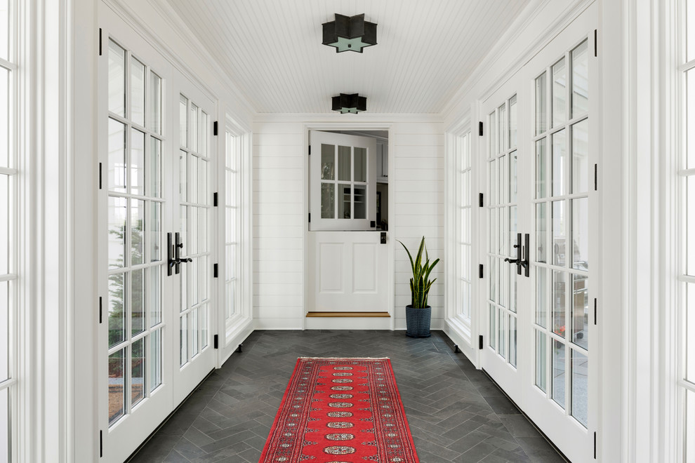 Design ideas for a beach style vestibule in Minneapolis with white walls, a stable front door, a white front door and grey floors.