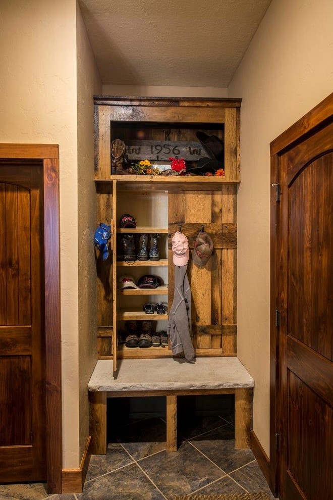 Photo of a medium sized rustic boot room in Other with beige walls, ceramic flooring, a single front door and a dark wood front door.