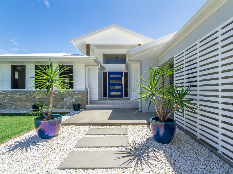 Coastal front door in Gold Coast - Tweed with white walls, concrete flooring, a single front door and a blue front door.