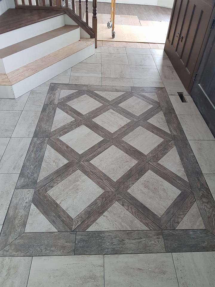 Example of a mid-sized classic ceramic tile entryway design in Calgary with white walls