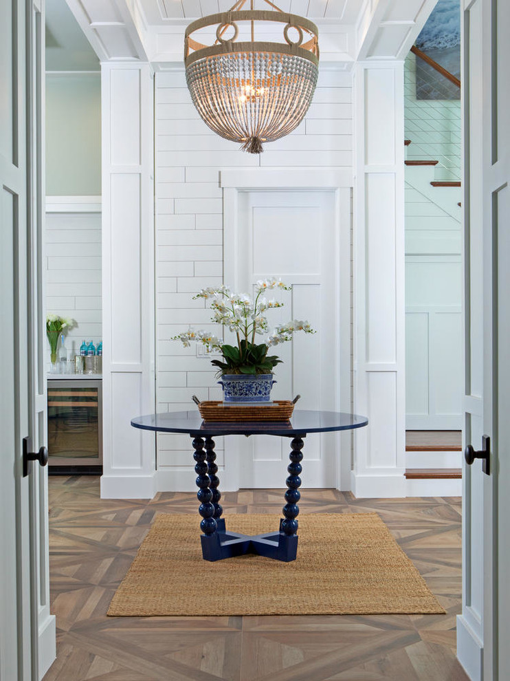 Medium sized nautical foyer in Miami with white walls, medium hardwood flooring, a double front door, a glass front door and brown floors.