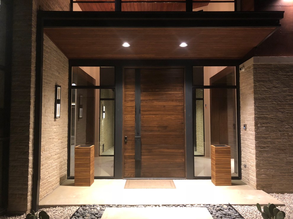 Photo of a large contemporary front door in Houston with a single front door and a dark wood front door.