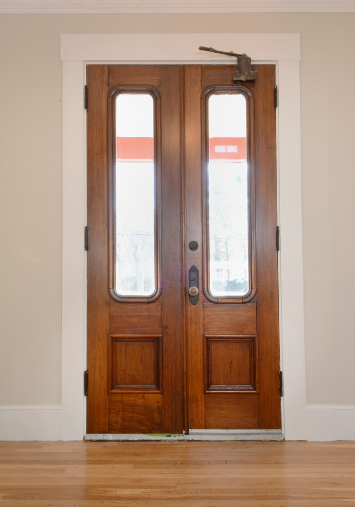 Пример оригинального дизайна: большая входная дверь в классическом стиле с белыми стенами, темным паркетным полом, двустворчатой входной дверью и входной дверью из темного дерева