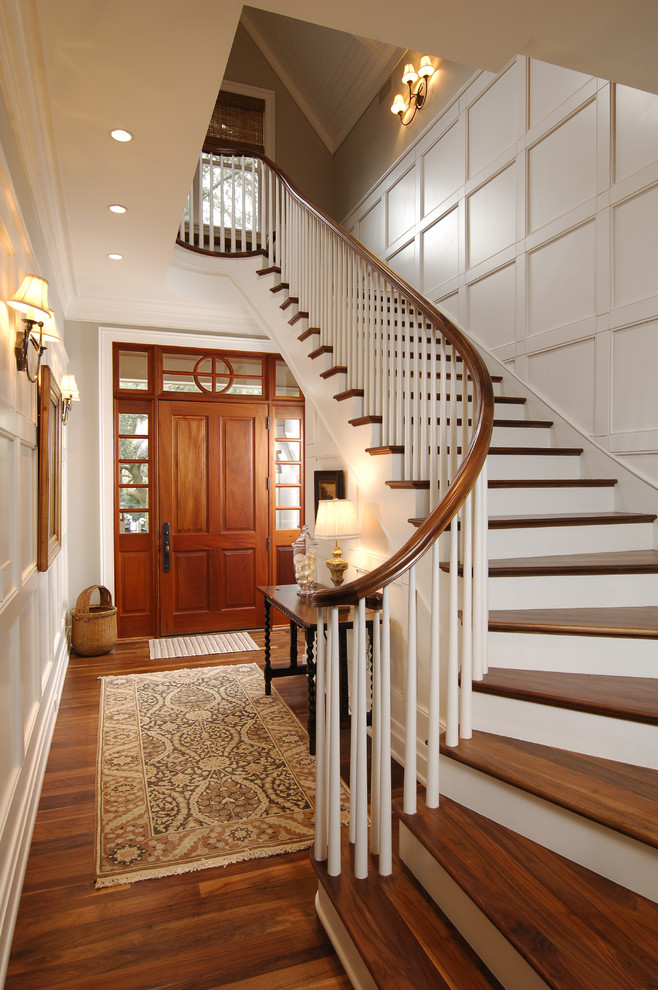 Design ideas for a classic entrance in Charleston with white walls, medium hardwood flooring, a single front door, a medium wood front door and feature lighting.