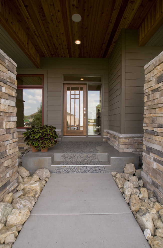 This is an example of a contemporary entrance in Minneapolis with a single front door and a glass front door.