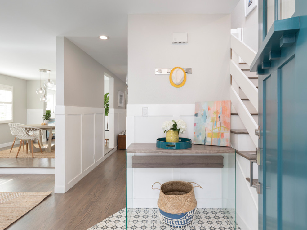 Photo of a medium sized nautical foyer in Los Angeles with grey walls, ceramic flooring, a single front door, a blue front door, multi-coloured floors and panelled walls.