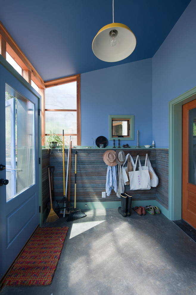 Стильный дизайн: вестибюль среднего размера в современном стиле с синими стенами, бетонным полом, одностворчатой входной дверью, синей входной дверью и серым полом - последний тренд