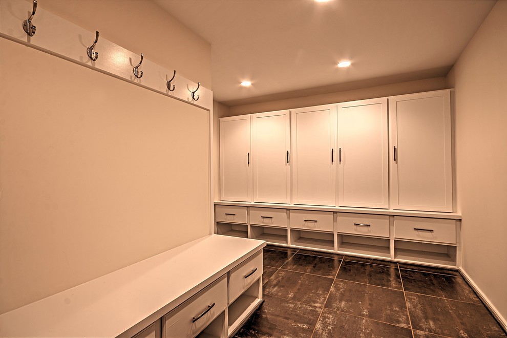This is an example of a medium sized contemporary boot room in DC Metro with grey walls and brown floors.