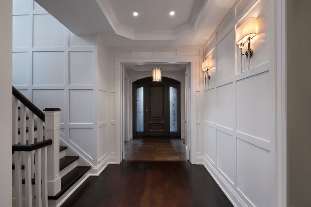 Großes Modernes Foyer mit weißer Wandfarbe, dunklem Holzboden, Einzeltür und dunkler Holzhaustür in Toronto