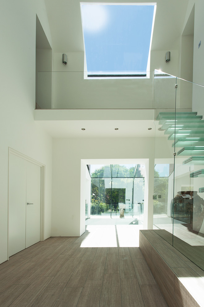 Photo of a contemporary foyer in Other with white walls.