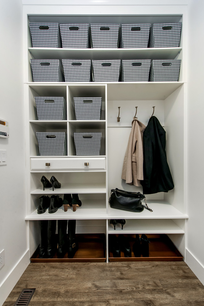 Medium sized contemporary boot room in Calgary with medium hardwood flooring and white walls.
