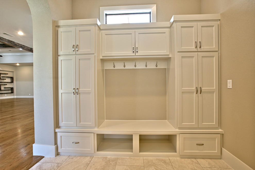 Photo of a large contemporary boot room in Dallas with white walls, ceramic flooring and a single front door.