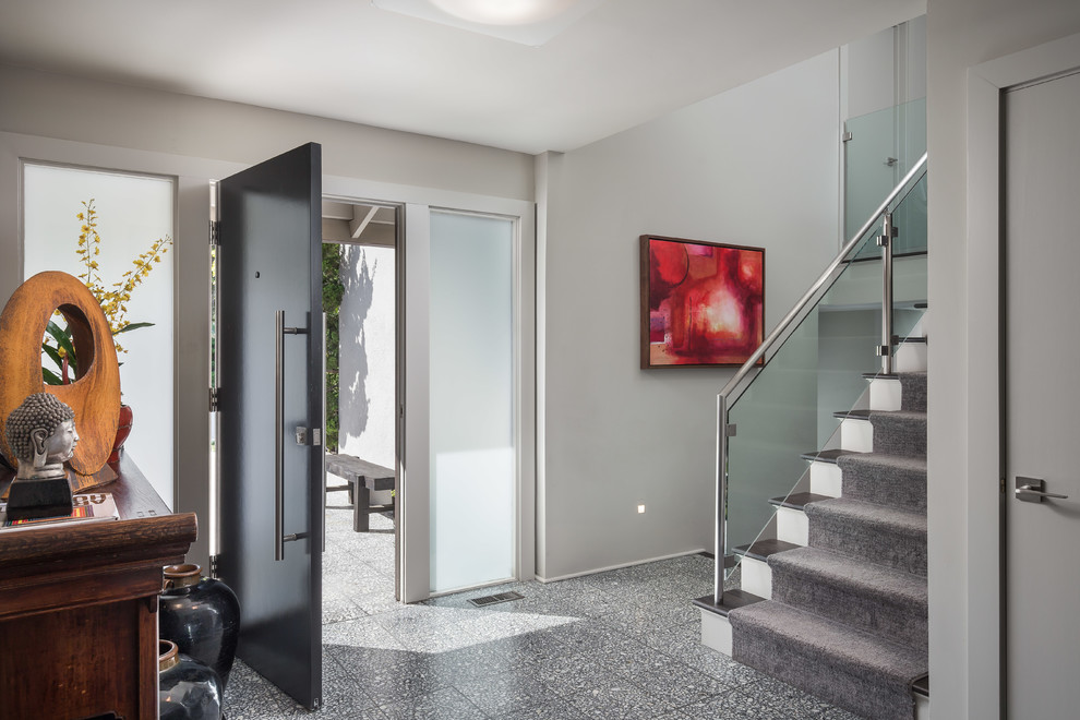 Medium sized contemporary foyer in Orange County with grey walls, a single front door, a black front door and grey floors.