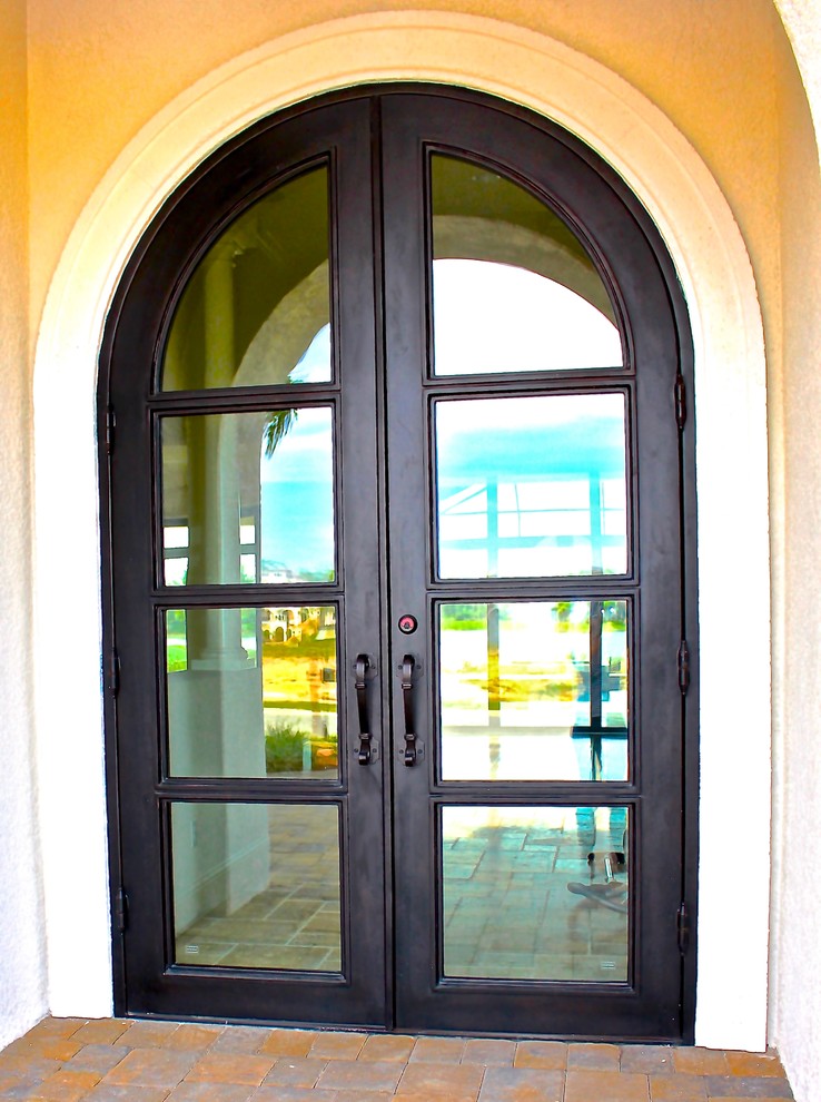 This is an example of a large contemporary front door in Miami with a double front door and a metal front door.