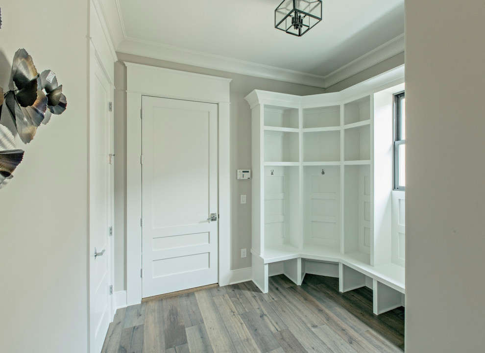 This is an example of a large contemporary boot room in Louisville with grey walls, dark hardwood flooring, a single front door and a white front door.