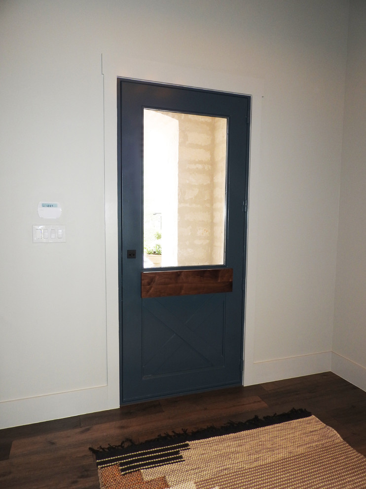 Immagine di una piccola porta d'ingresso design con una porta a pivot