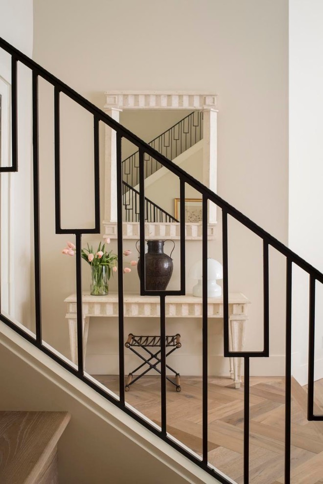 Example of a mid-sized trendy medium tone wood floor entryway design in Orlando with beige walls