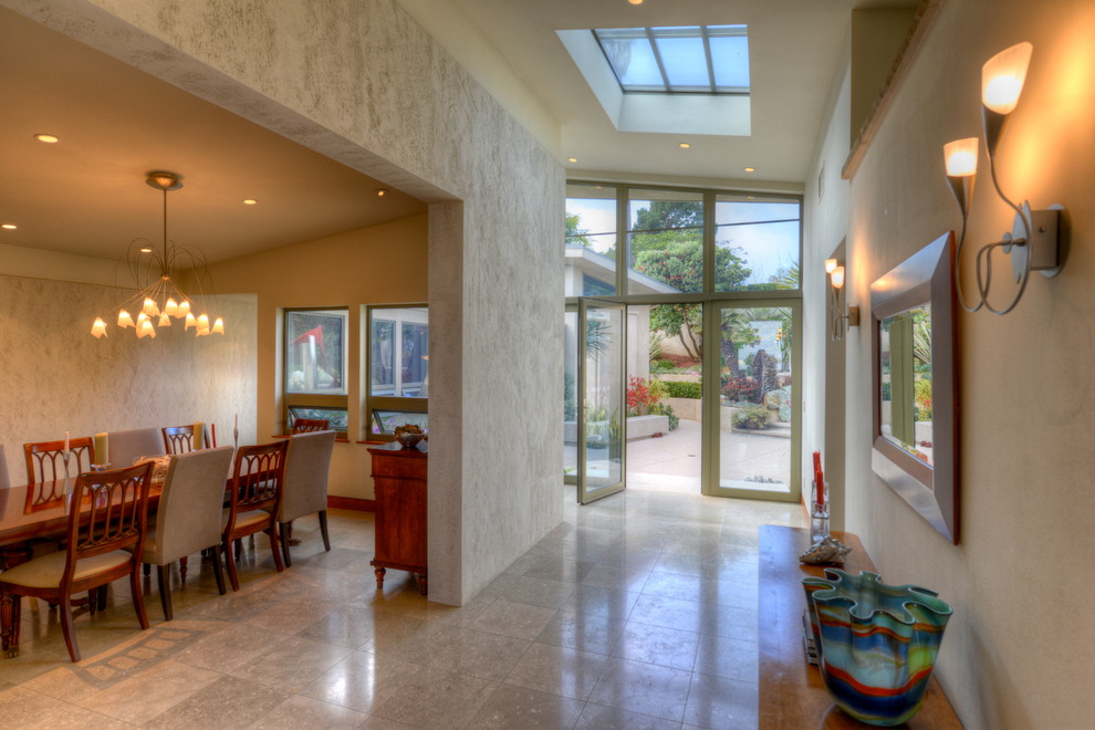 This is an example of a medium sized contemporary front door in San Diego with beige walls, ceramic flooring, a double front door and a glass front door.