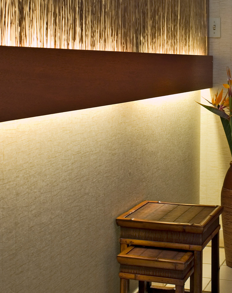 Inspiration for a world-inspired entrance in Hawaii with beige walls and limestone flooring.