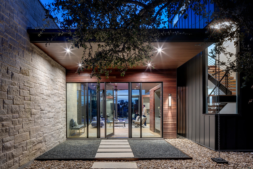 Inspiration for a contemporary front door in Austin with a pivot front door and a glass front door.
