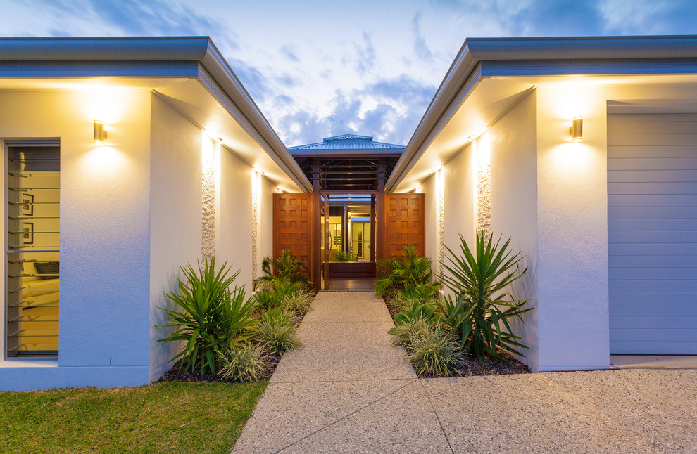 Inspiration for a modern entrance in Sunshine Coast with white walls, a pivot front door and a medium wood front door.